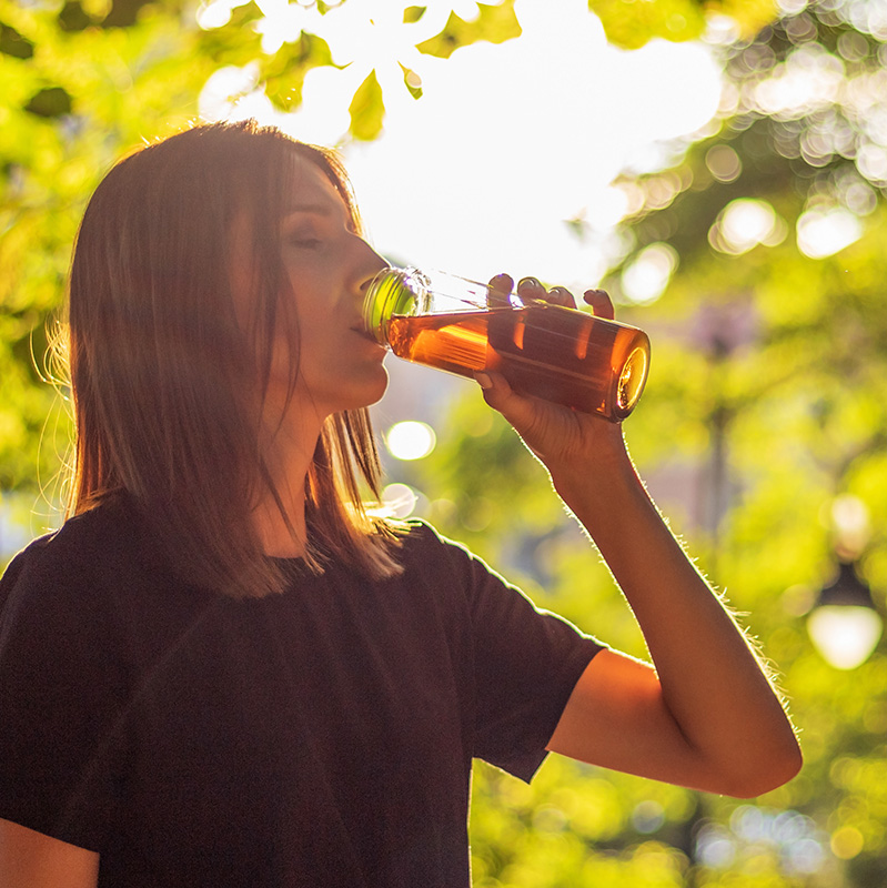 woman enjoying iced tea on a sunny afternoon woman enjoying iced tea on a sunny afternoon