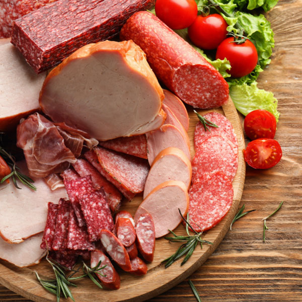 sliced deli meats on wooden tray
