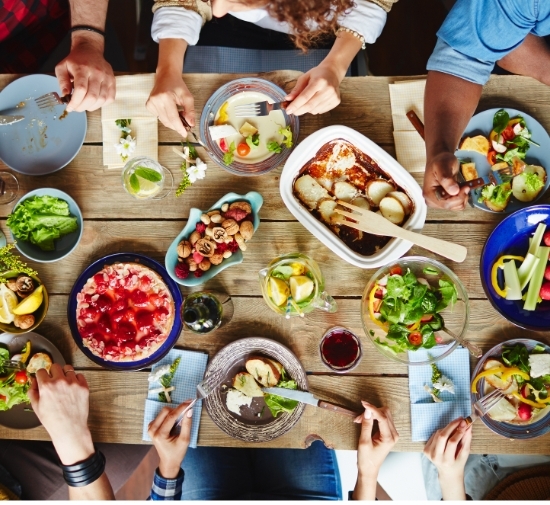 sustainability-550×505 people enjoying a meal at table
